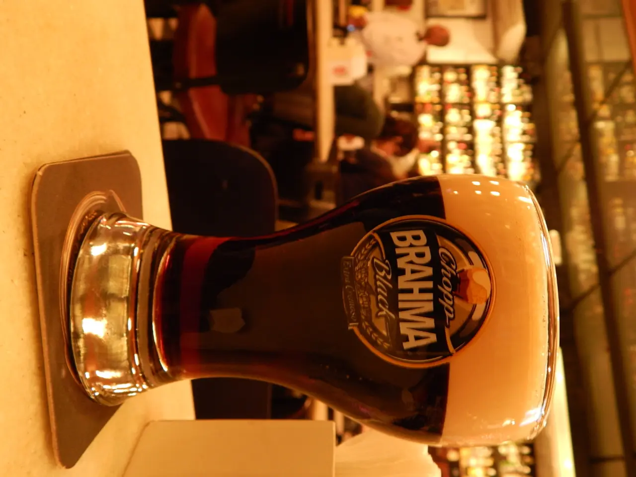 In this image there is a glass of wine on the plate and a tissues box on the path , and in the...