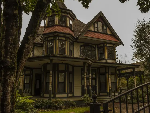 In the image we can see yellow color building with red color rooftop. On the top there is sky and...